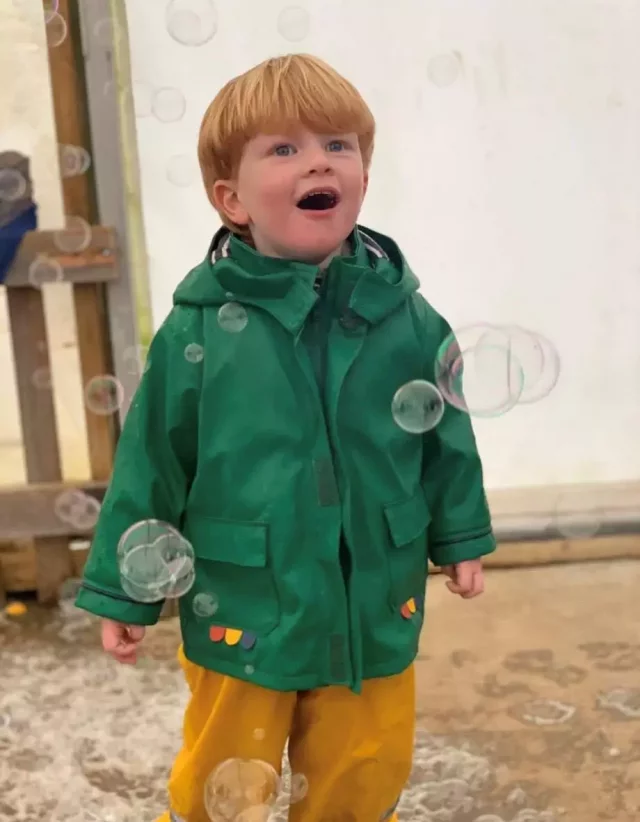 A child playing with bubbles at Bubbles & Boogie