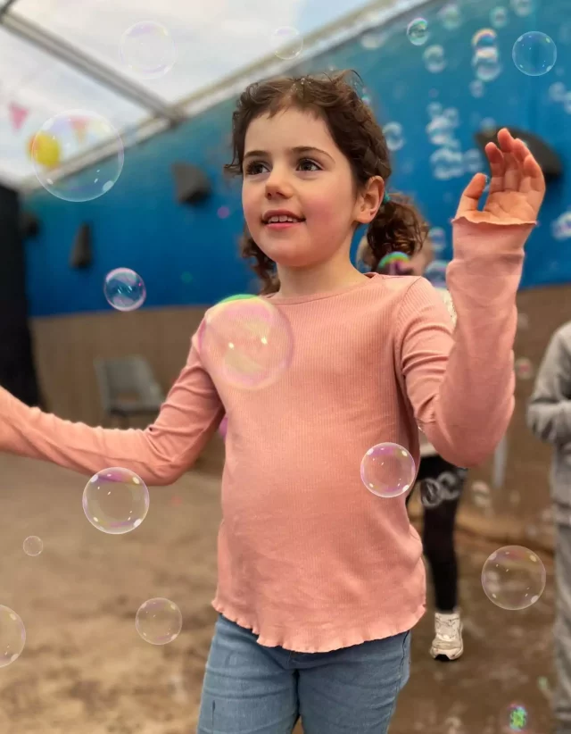 A child catching bubbles at Odds Farm Park