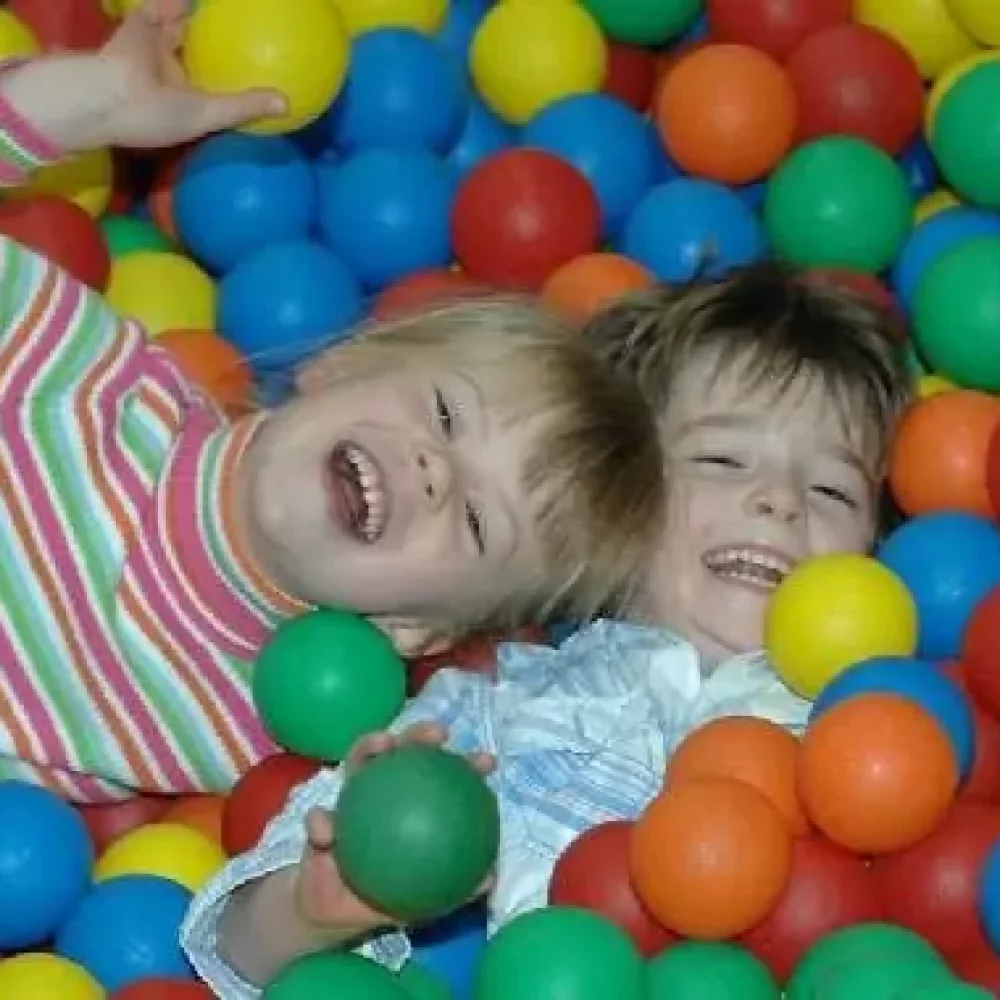 A child playing in the indoor ball pit
