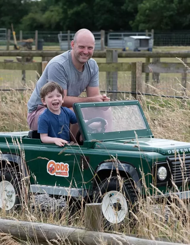 A child driving a miniature Land Rover