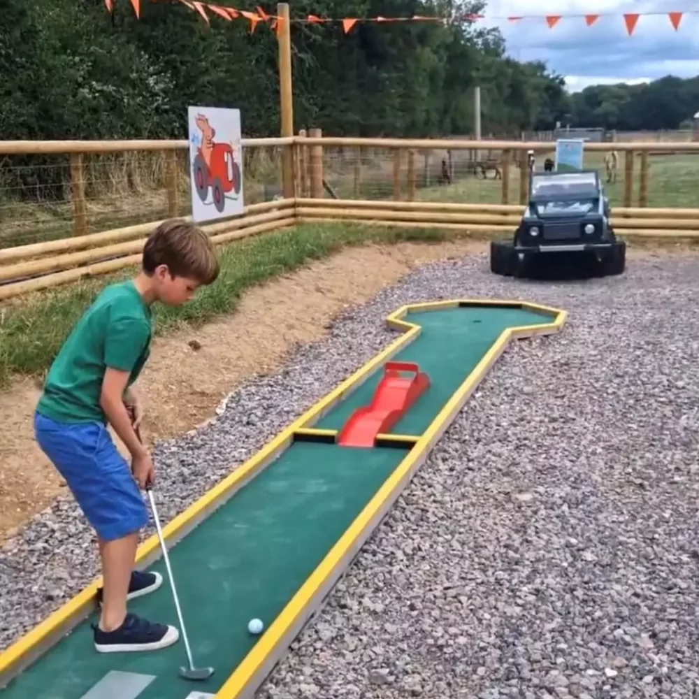 A family playing mini golf