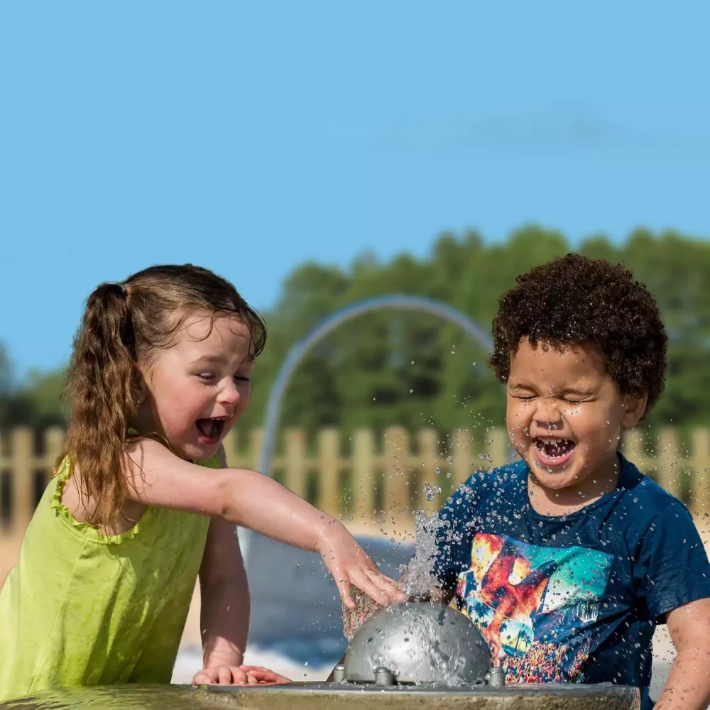 Children splashing in the water play area
