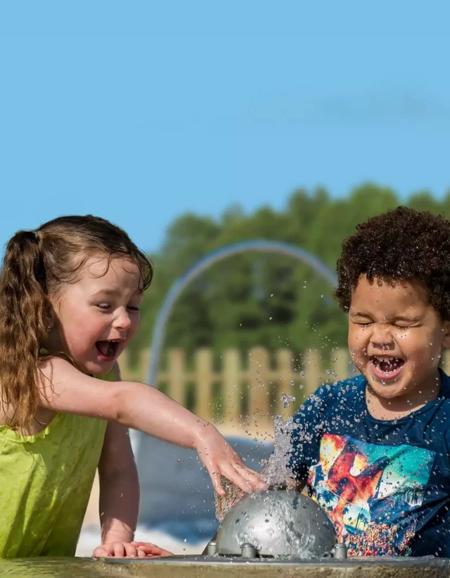 Children splashing in the water play area
