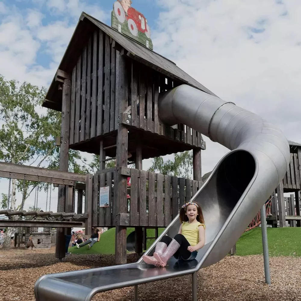 Outdoor adventure play tower and slides